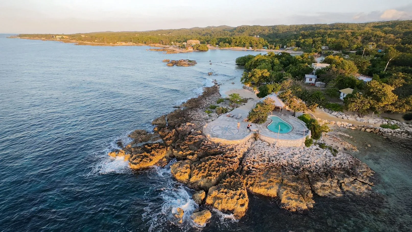 A small Caribbean island surrounded by clear water off Jamaica