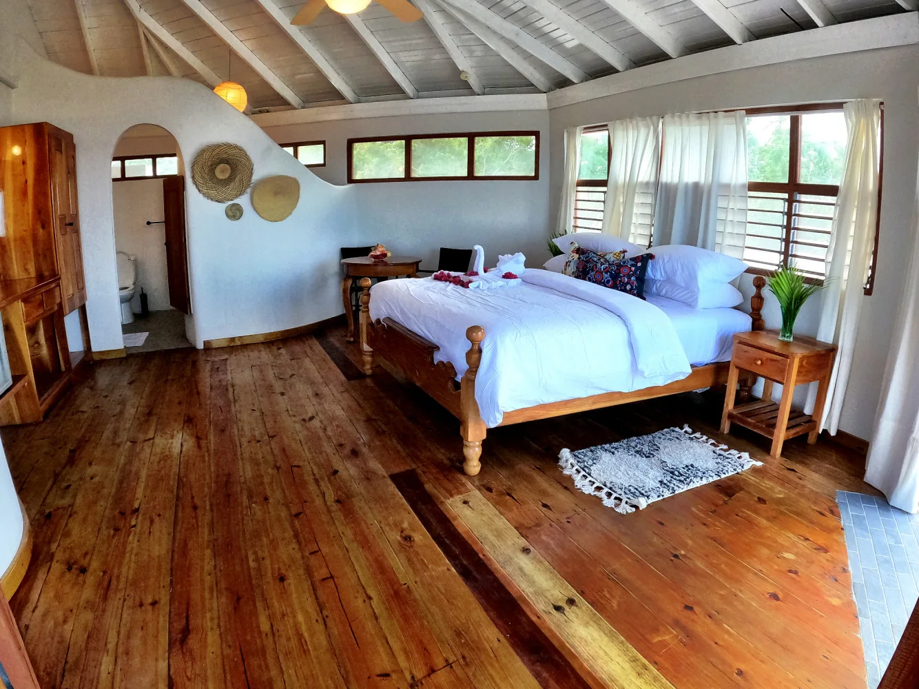 Airy bedroom with wood floors — Starlight, Coral Cove Wellness Resort