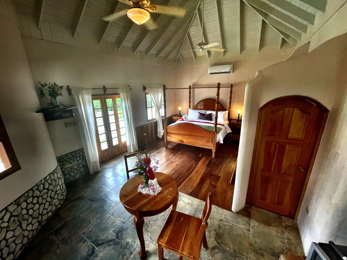 Stone-cottage bedroom and sitting area — The Tree Top Cottage, Coral Cove Wellness Resort
