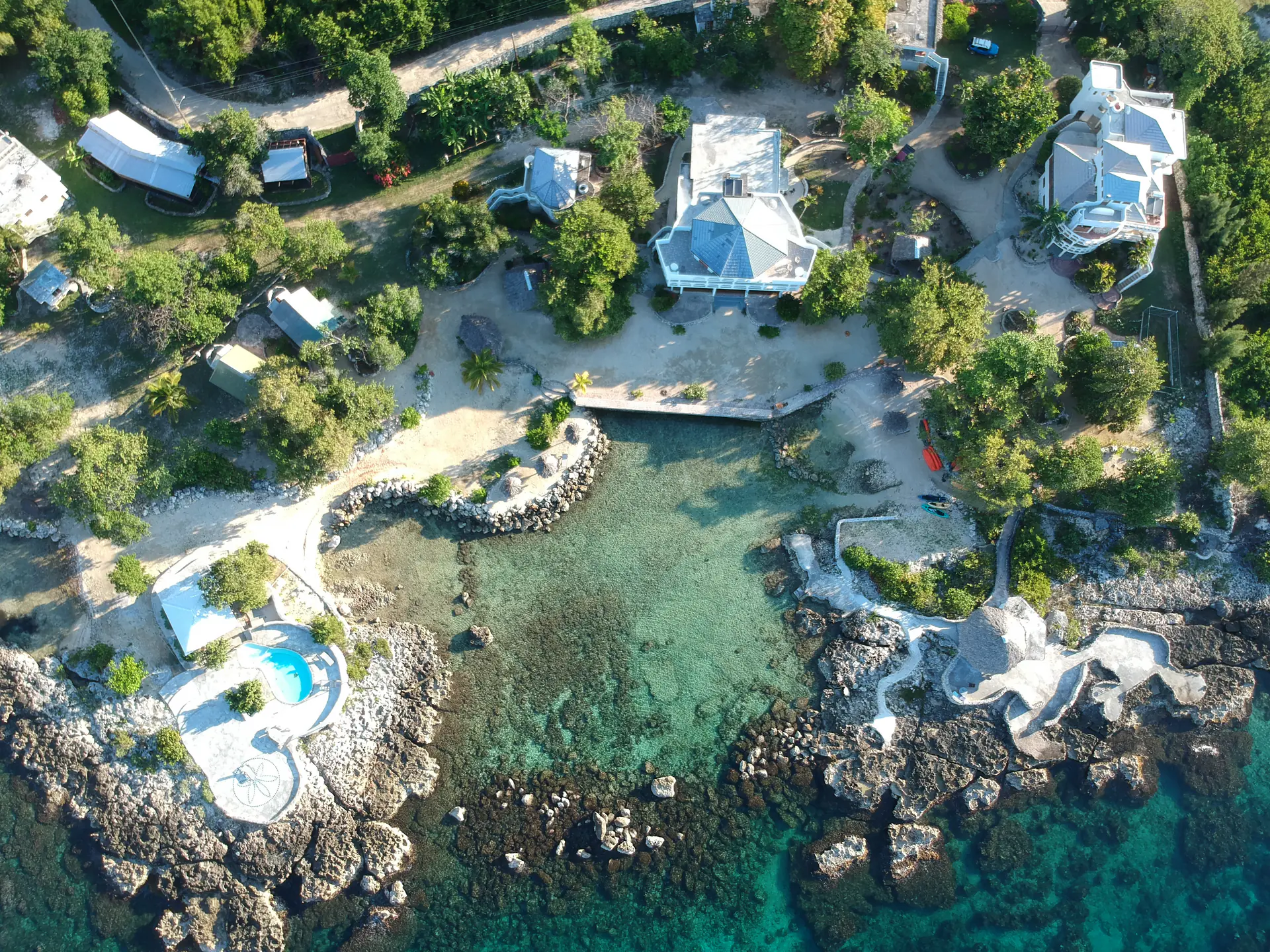 Aerial view of Coral Cove surrounding its private Caribbean cove