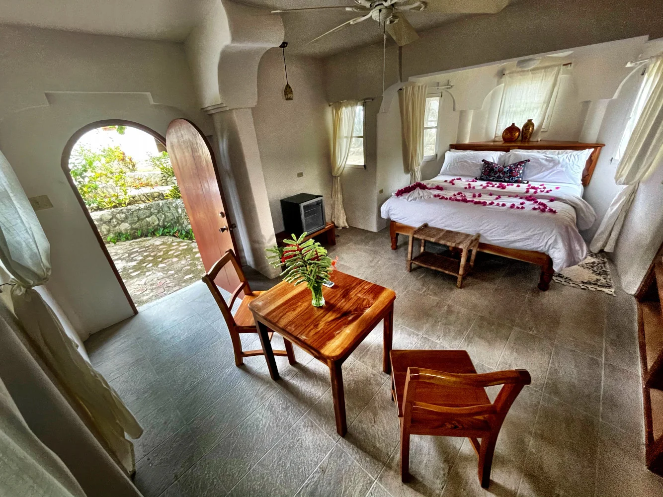 Ground-level bedroom opening to the patio — Night Jasmine, Coral Cove Wellness Resort