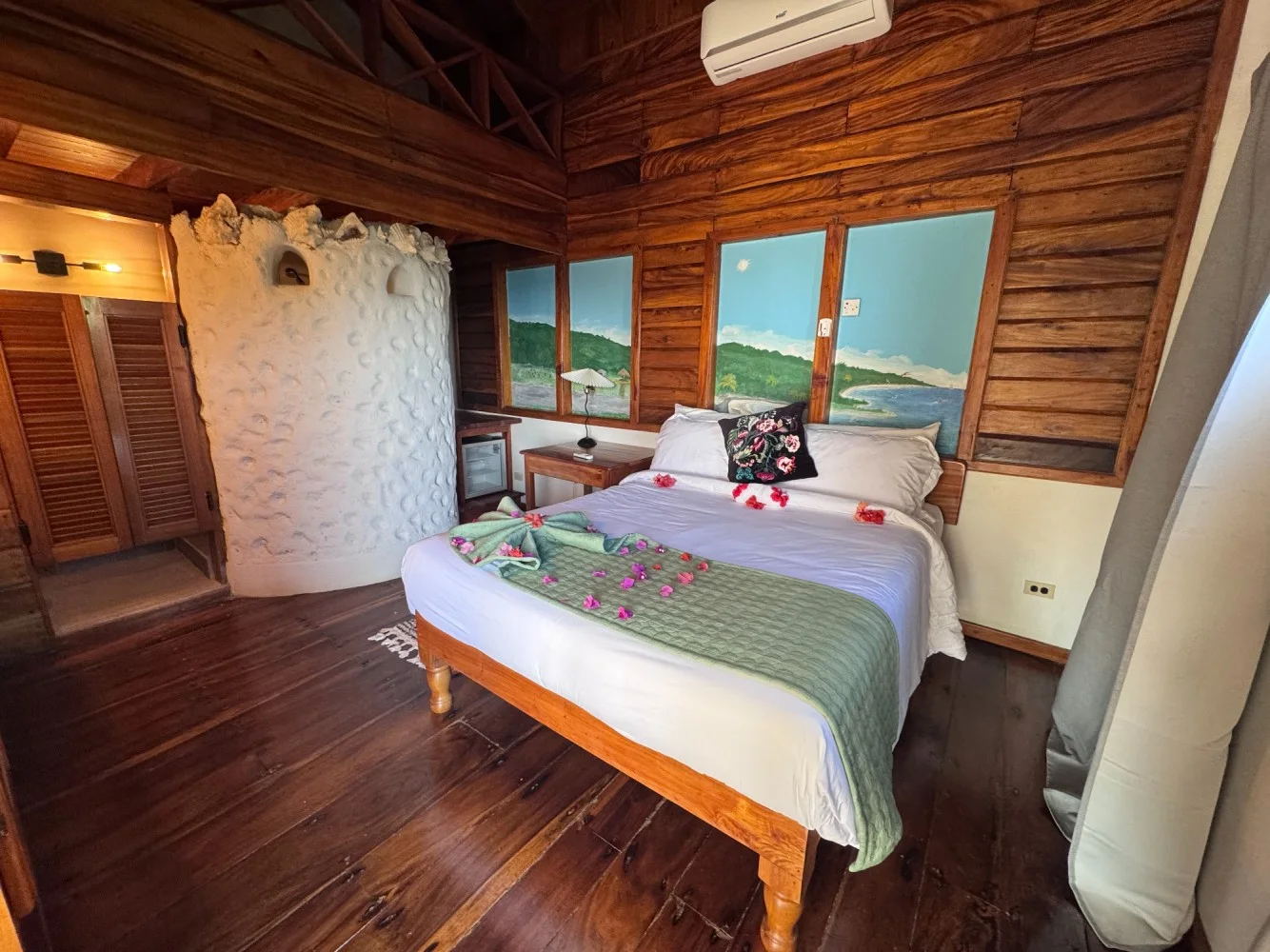 Queen bedroom with wood finishes — The Queen Conch, Coral Cove Wellness Resort