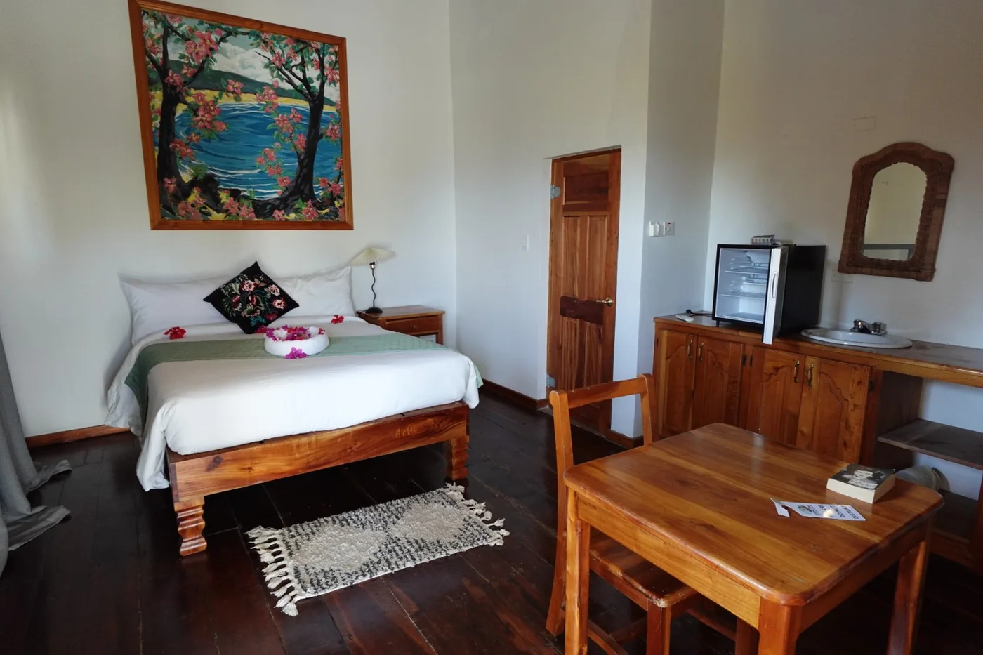 Bedroom with wood floors and sitting area — The Seagrape, Coral Cove Wellness Resort