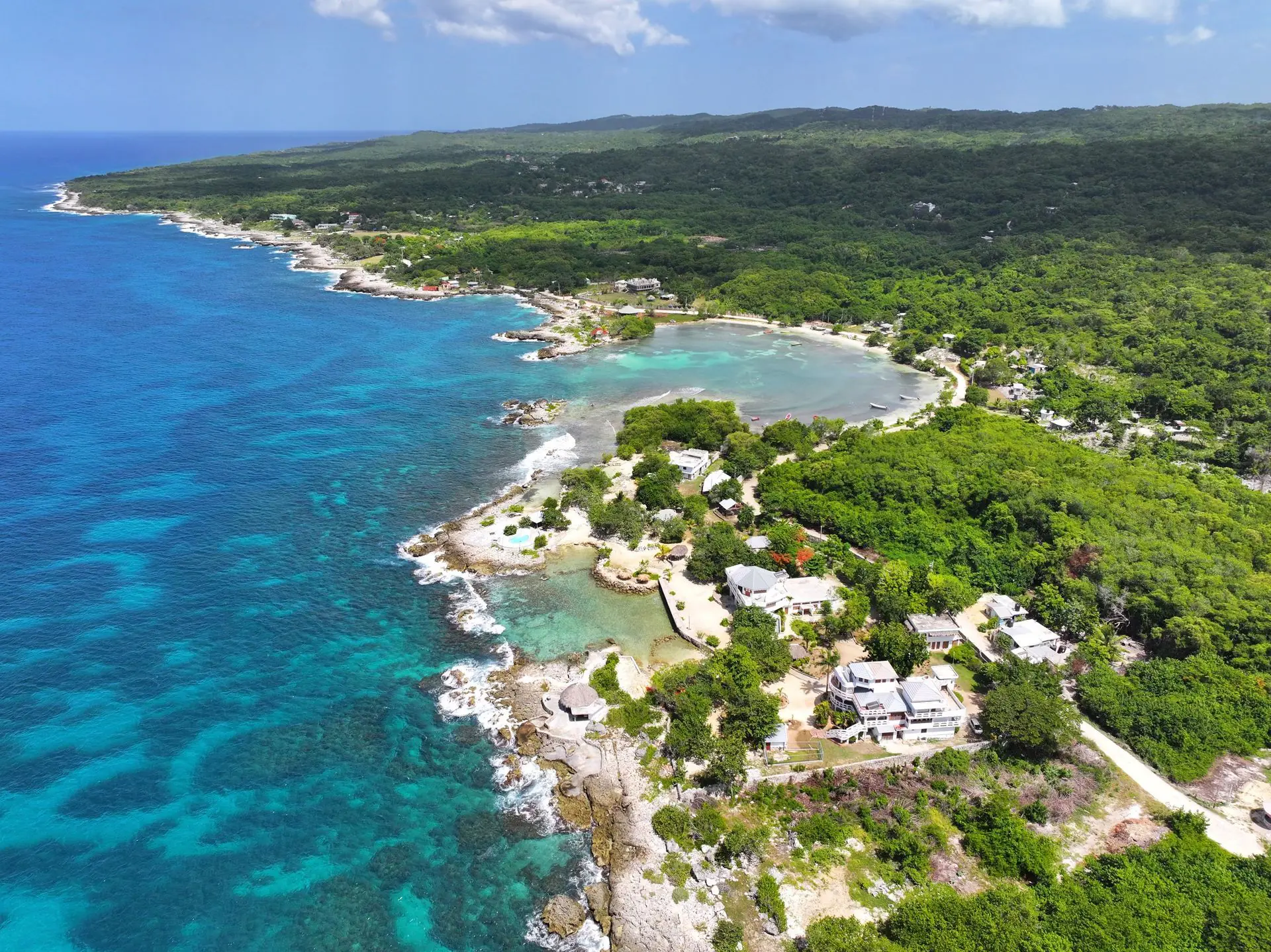 Aerial view of Coral Cove Wellness and Jamaica's Caribbean coast
